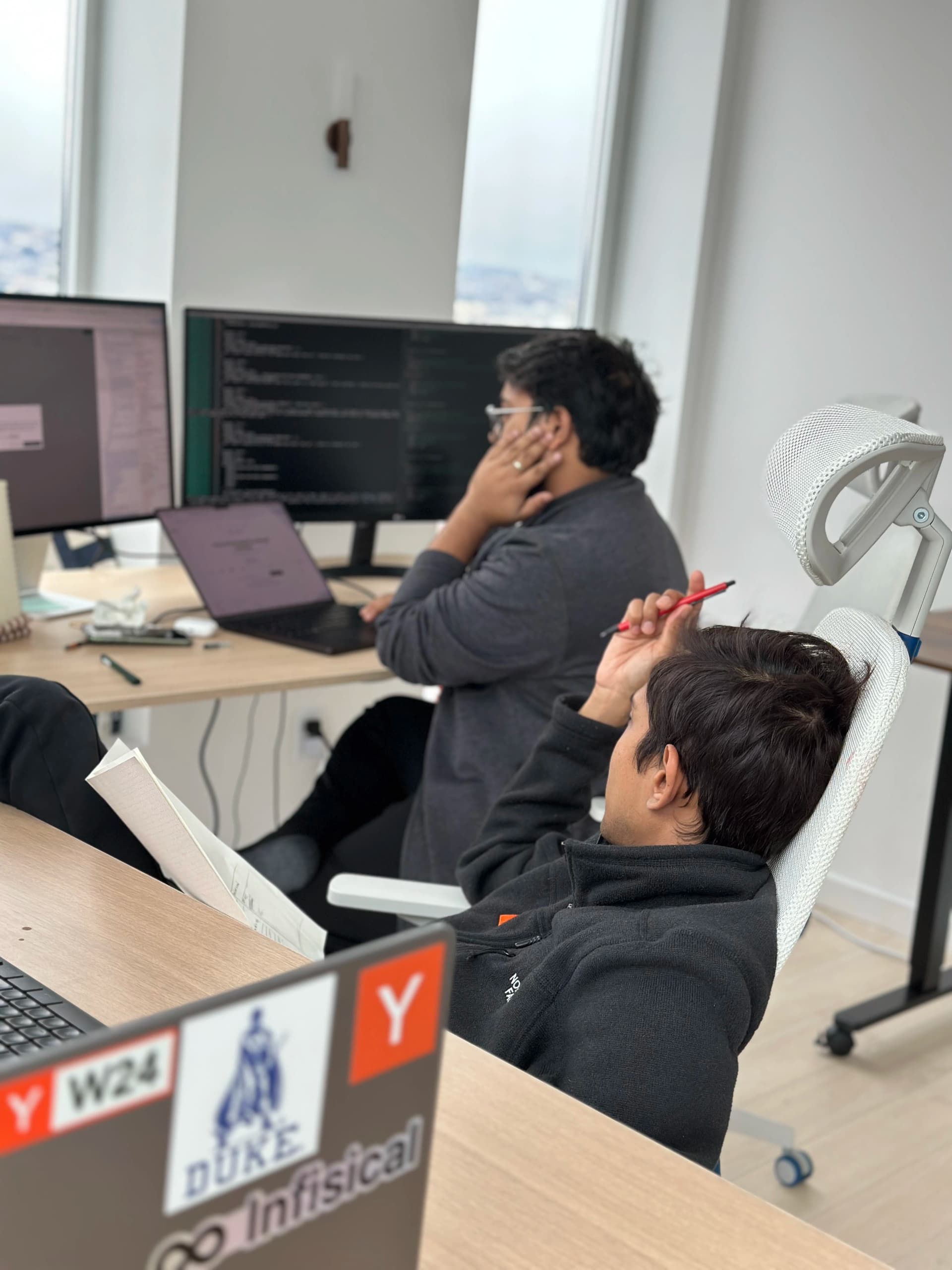 Two employees working with computers